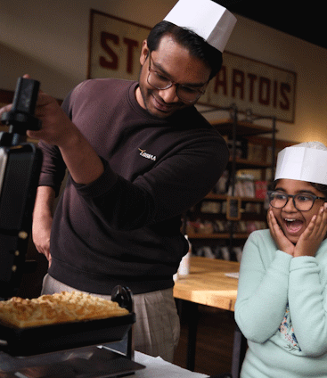 family opening waffle iron at the waffle workshop in brussels